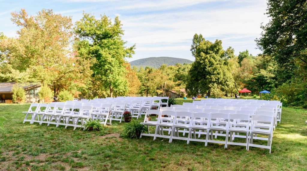 Wedding ceremony set beneath the trees at Love Ridge Mountain Lodging